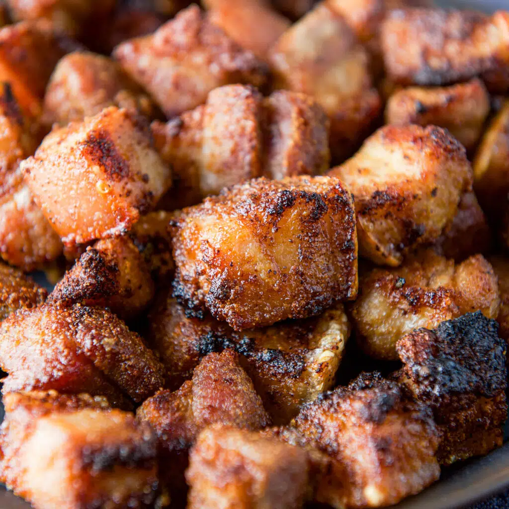 Close up view of crispy pork belly chunks - square