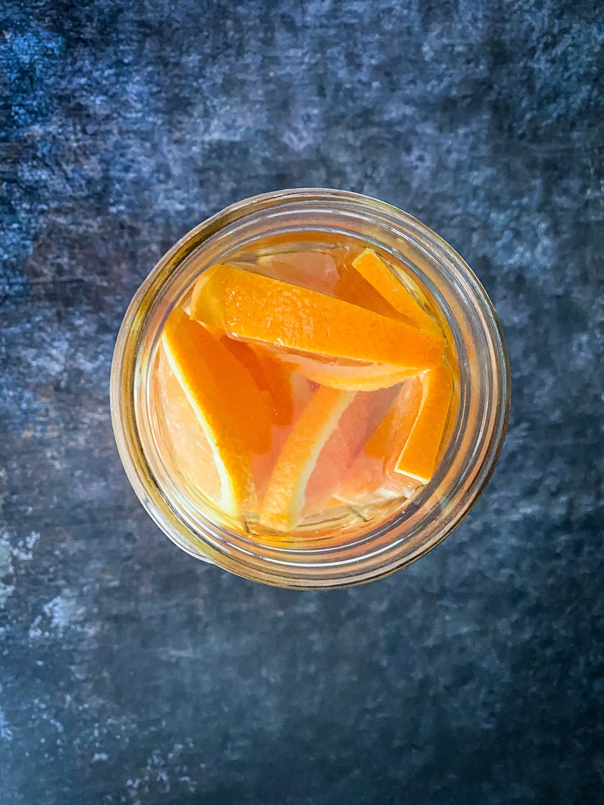 Overhead view of oranges and vodka in the jar