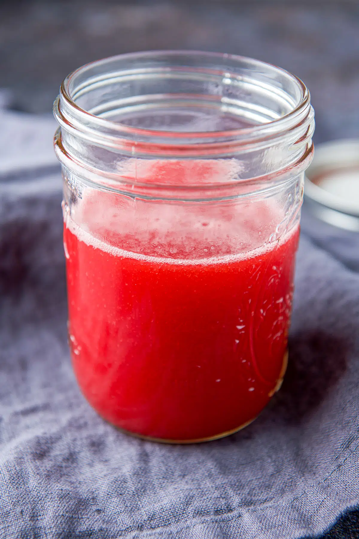 A jar with the sweetened raspberry in it