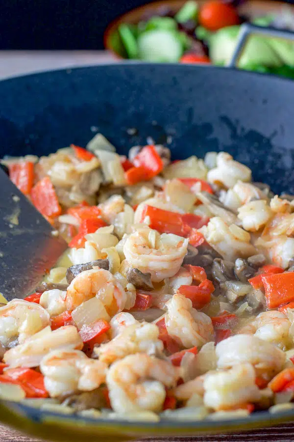 Shrimp added to the wok full of vegetables