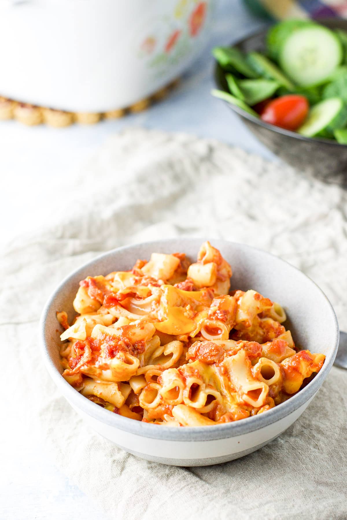 Close up of the tomato pasta in the grey bowl
