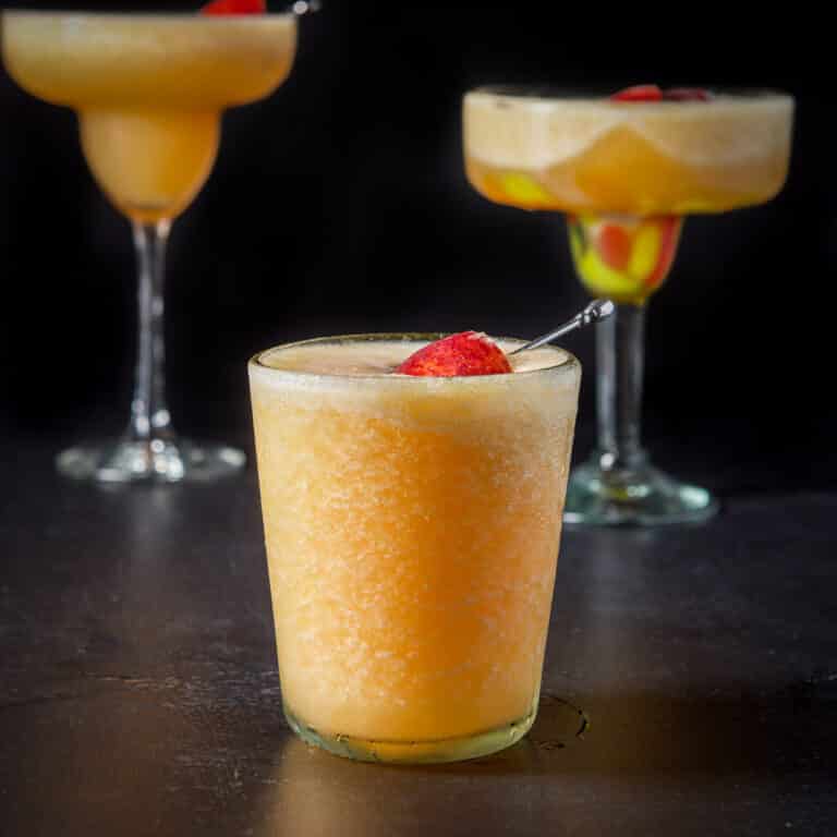 Three glasses with the peach orange drink in them - square