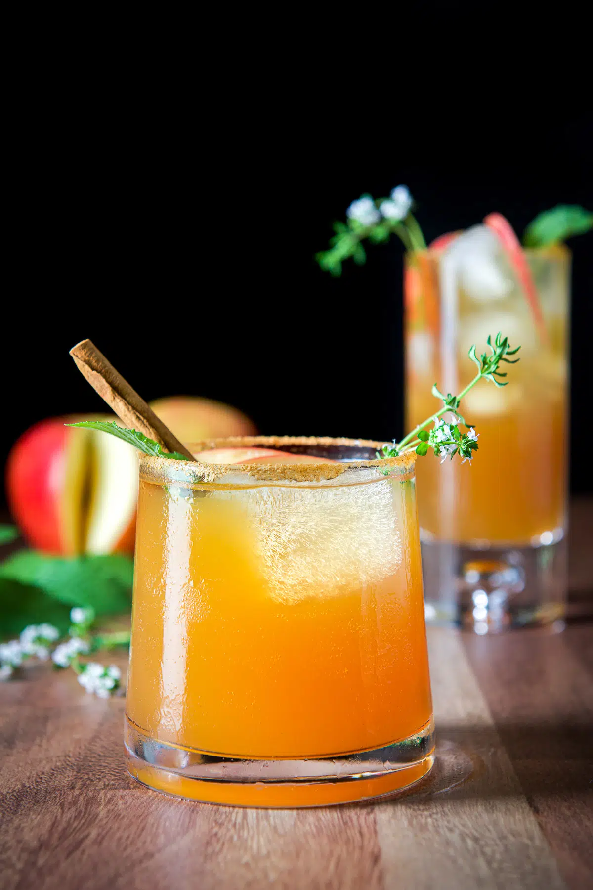 Vertical view of the two glasses filled with the apple spritzer