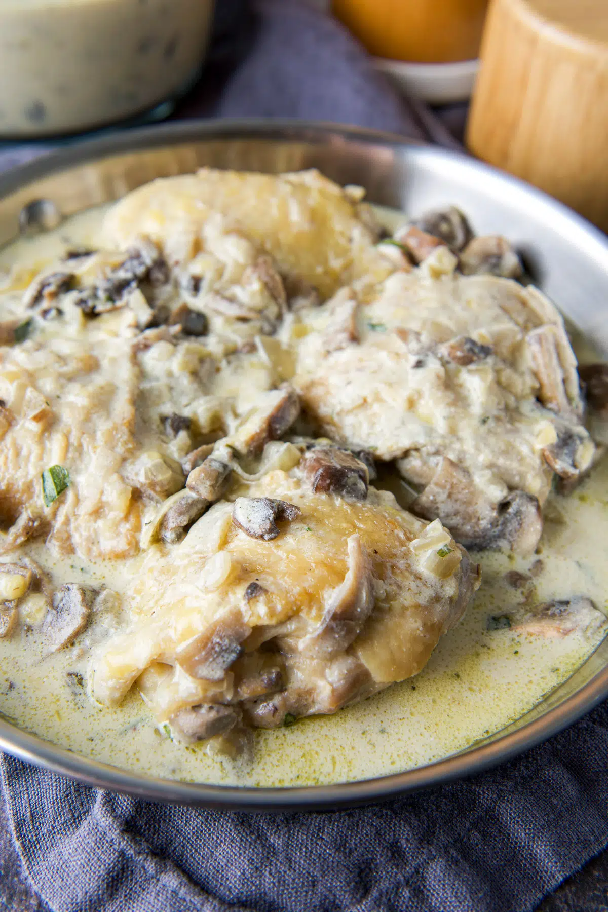 Close up of the chicken thighs with sour cream sauce in a steel pan