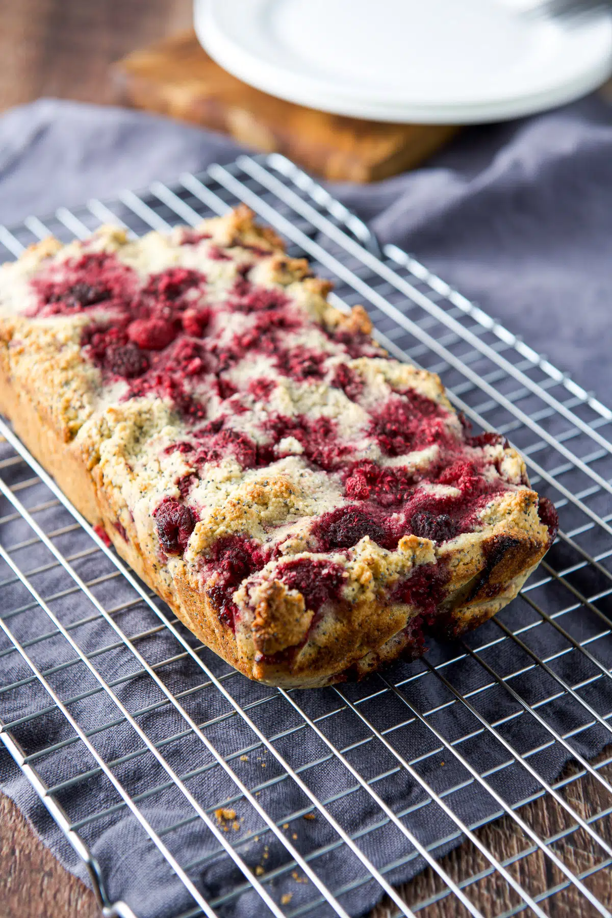 raspberry bread out of the pan cooling on a metal rack