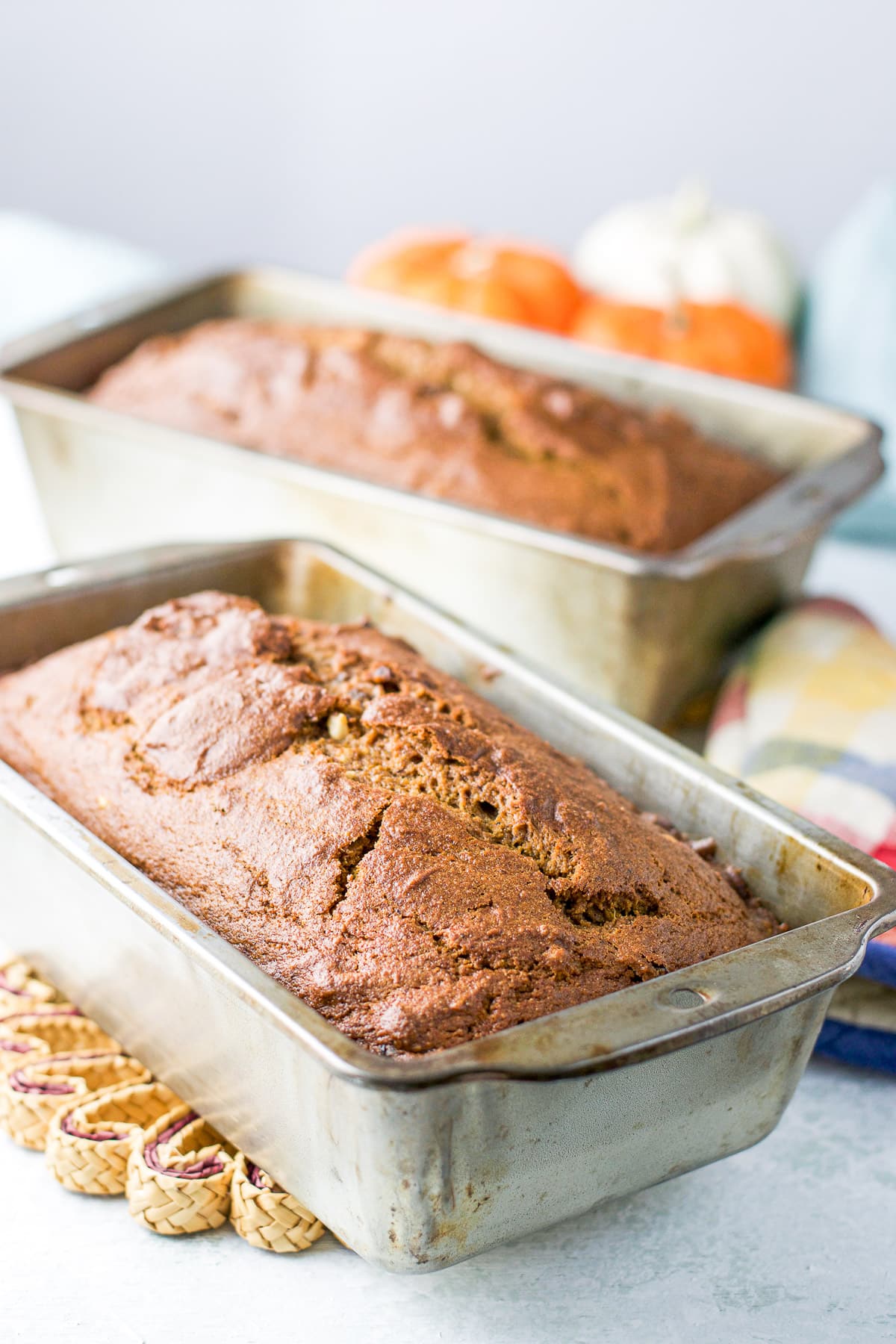 Two baking pans fresh out of the oven with the pumpkin bread in it
