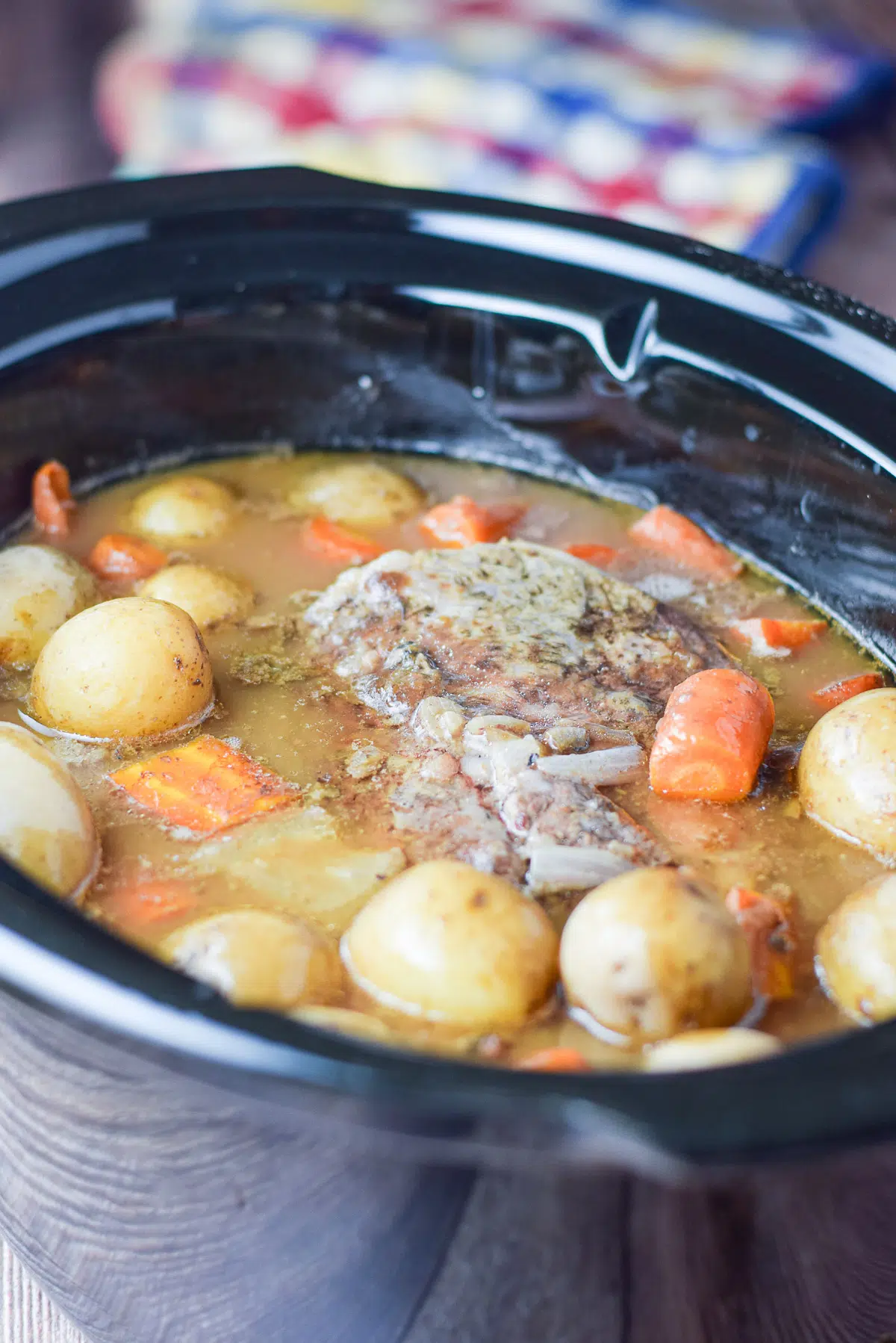Crockpot with the pot roast, vegetables, and gravy