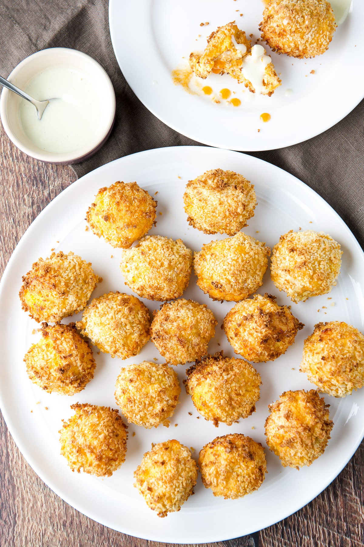 Overhead view of a big plate with the appetizer in and a small plate with chicken bites on it