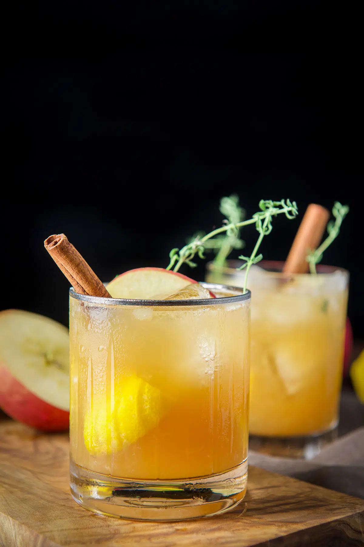 Vertical view of the beveled glass with the bourbon smash with cinnamon, apple and thyme