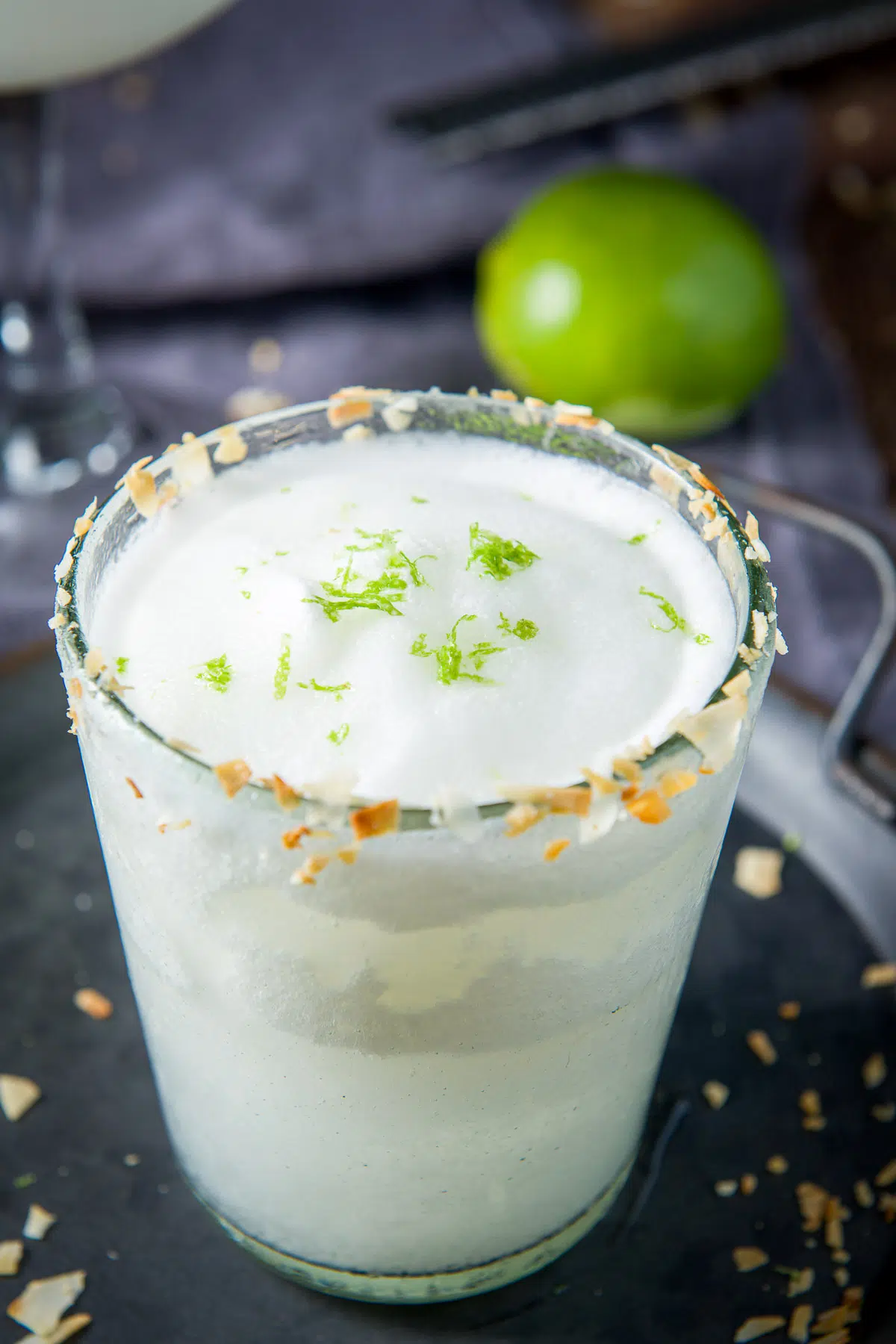 Close up of the coconut margarita with lime zest and toasted coconut
