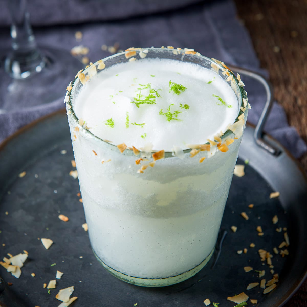 Square view of the frozen margarita on a tray with coconut