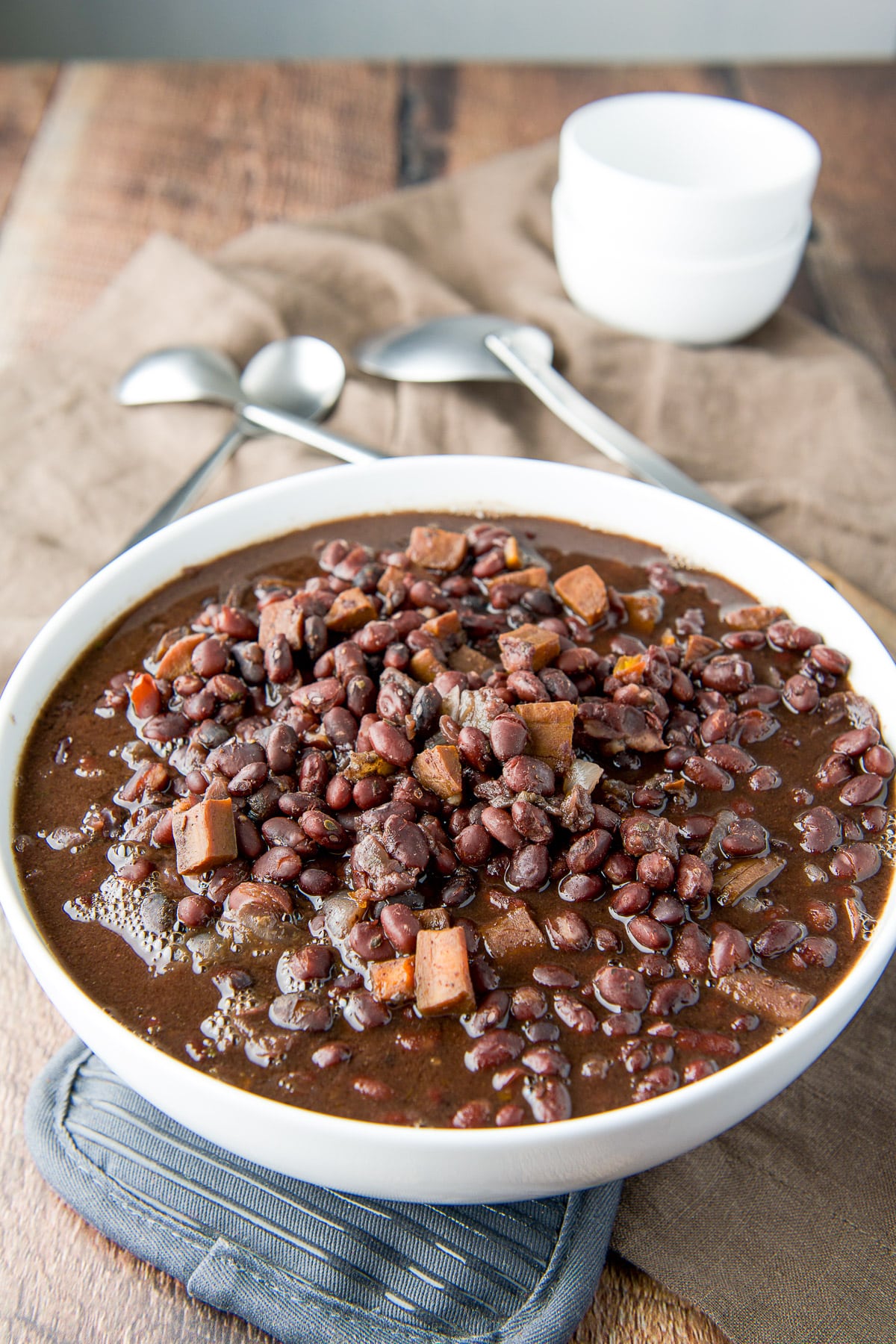 A big serving bowl filled with the black beans and carrots