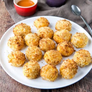 Big plate filled with the chicken bites with sauce in the back - square