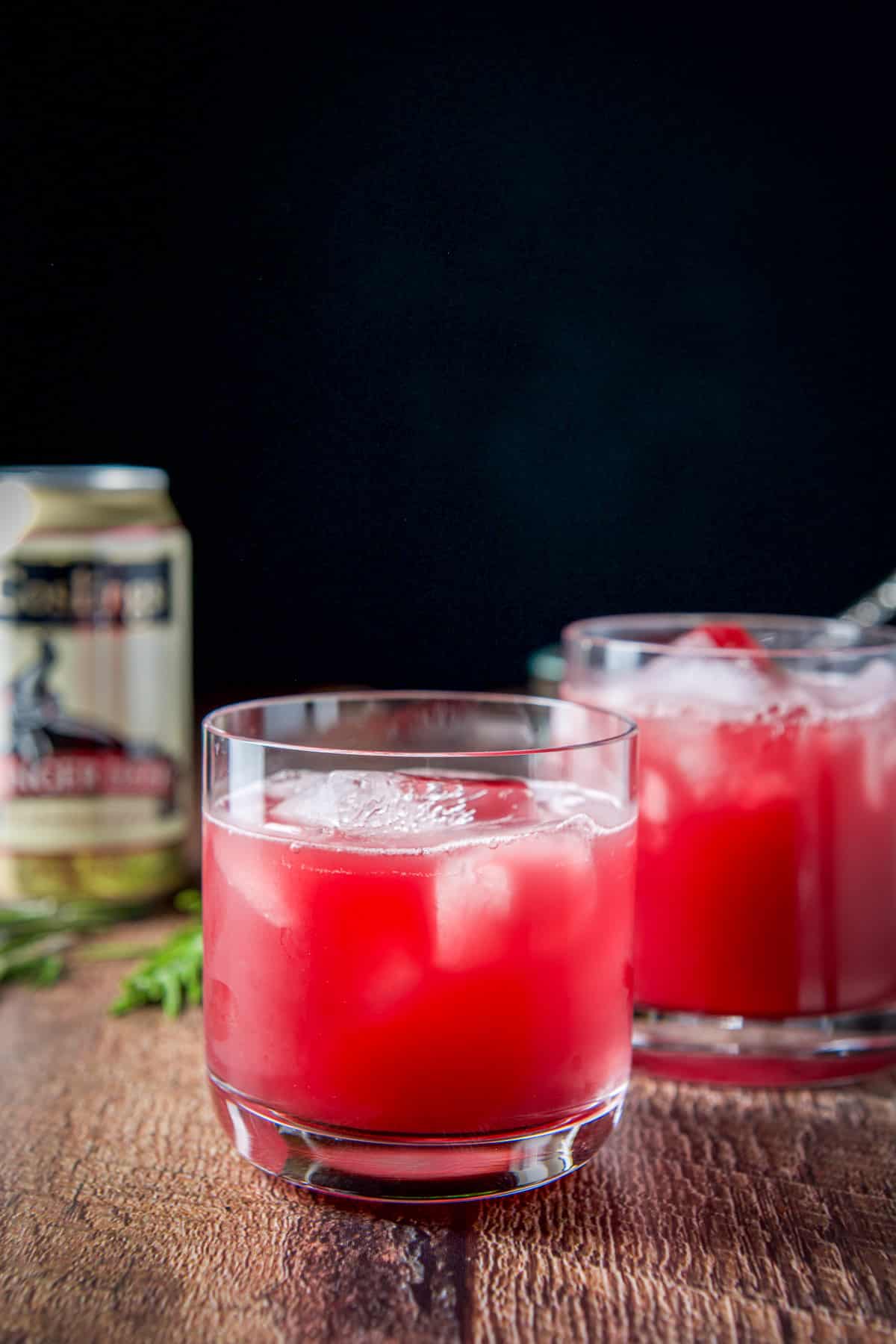 The holiday cocktail poured into the two glasses with ginger beer in the back