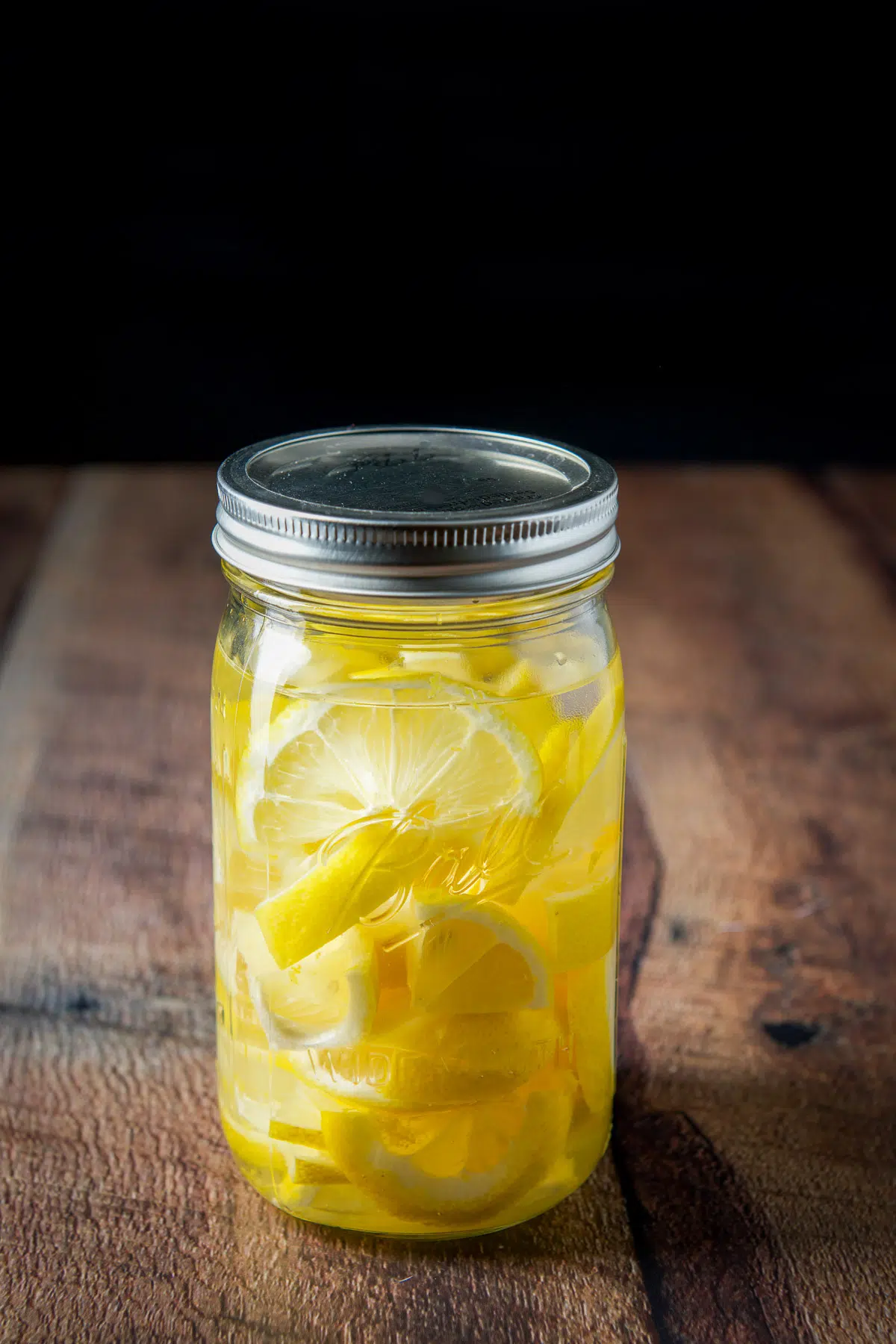 The vodka in a sealed jar with the lemon slices