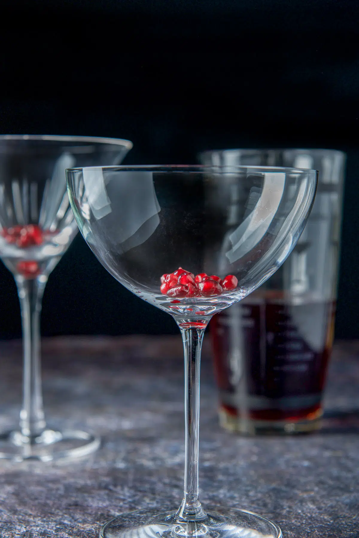 Two glasses with pomegranate seeds in them