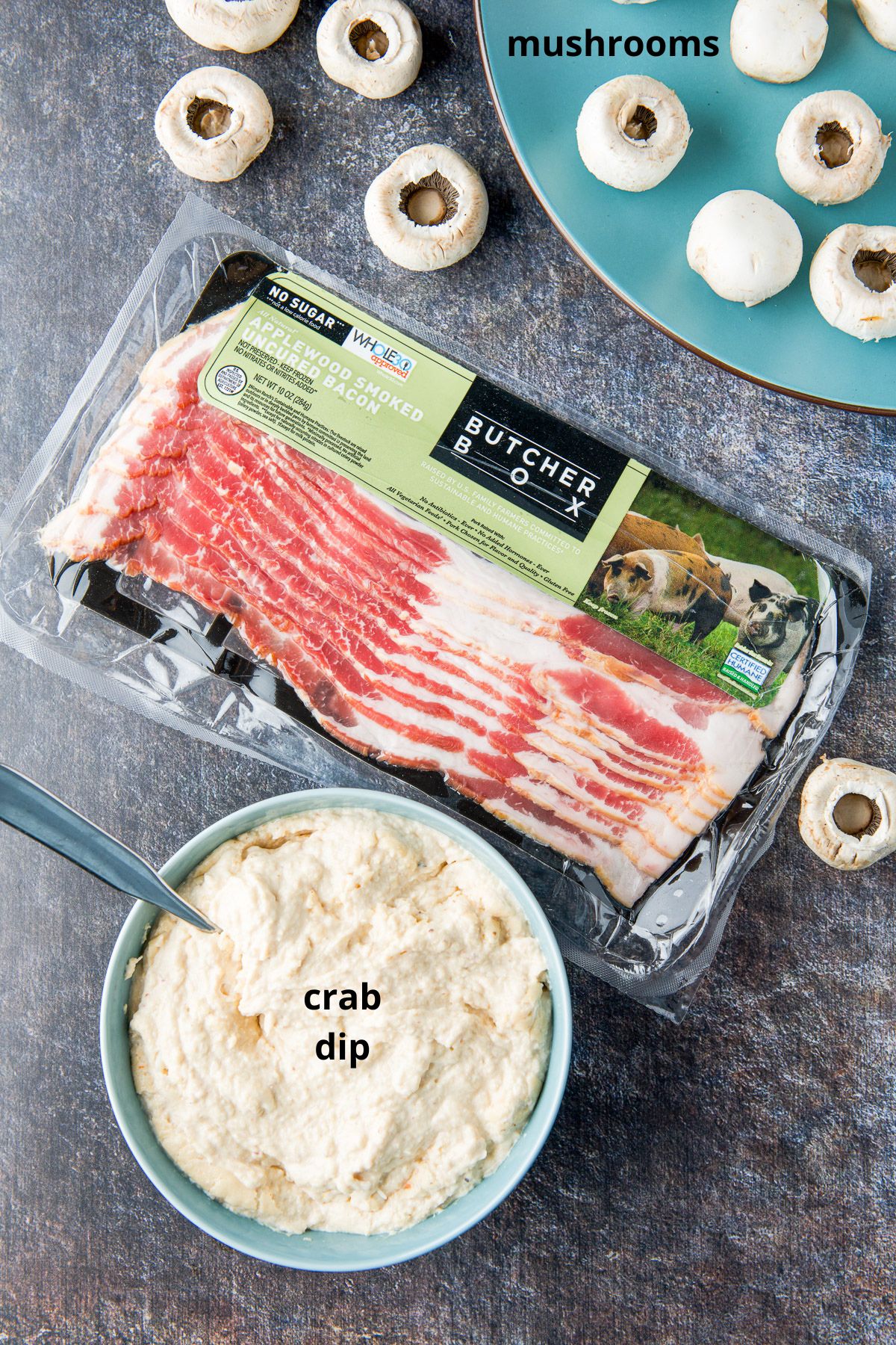 bacon, mushrooms and crab dip on a table