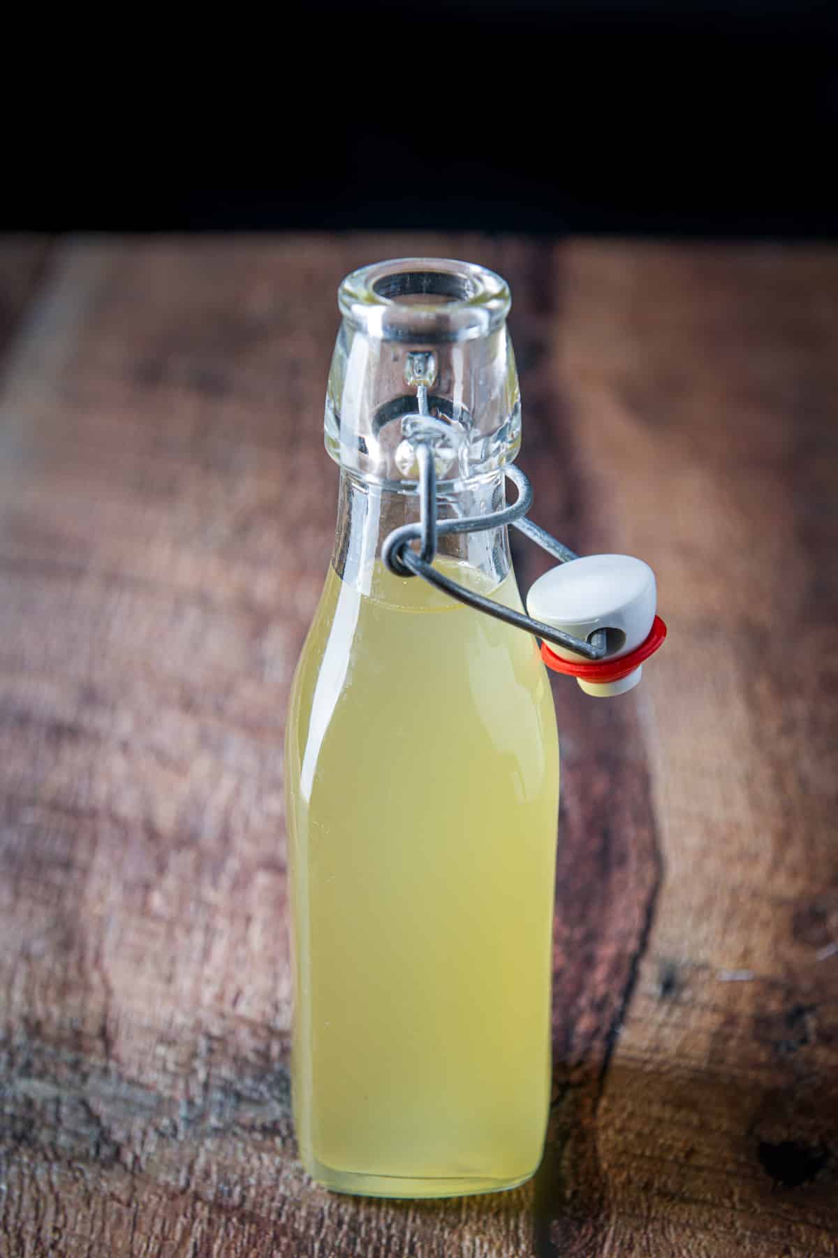 A bottle of ginger syrup with the top off