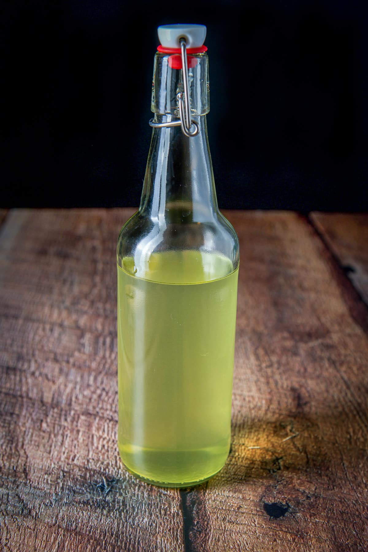 A capped bottle with the yellow vodka in it