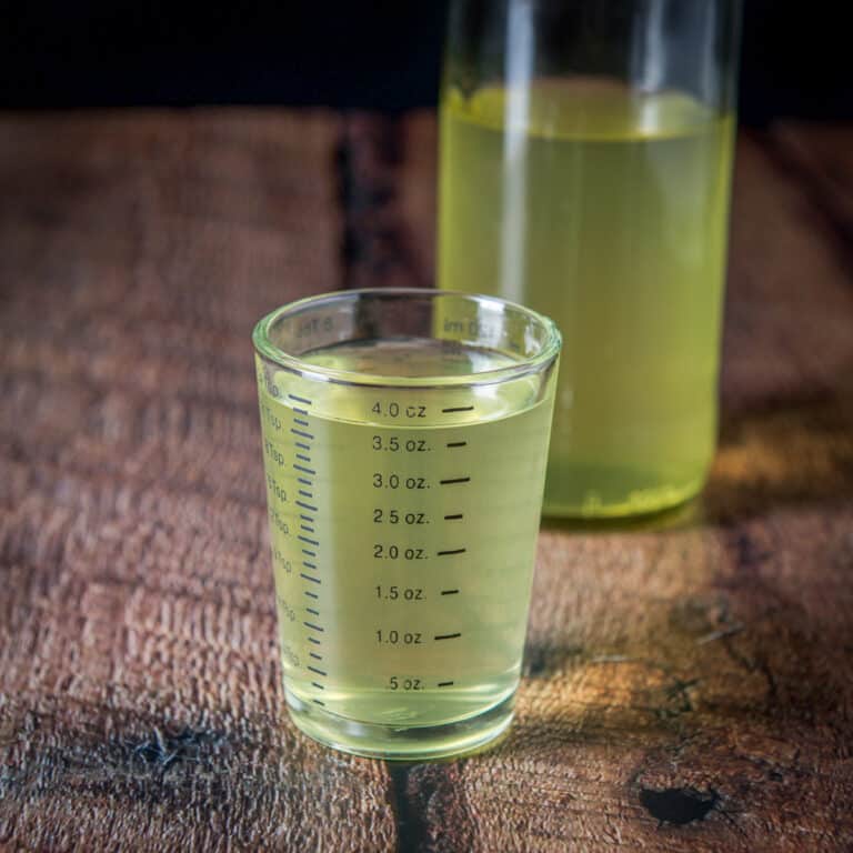 Square photo with the measured out vodka with the bottle in back