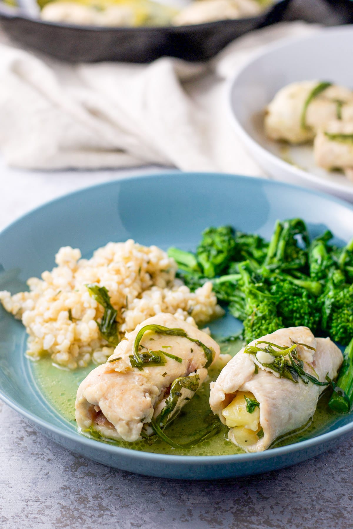 Chicken saltimbocca in a deep dish along with broccoli and rice