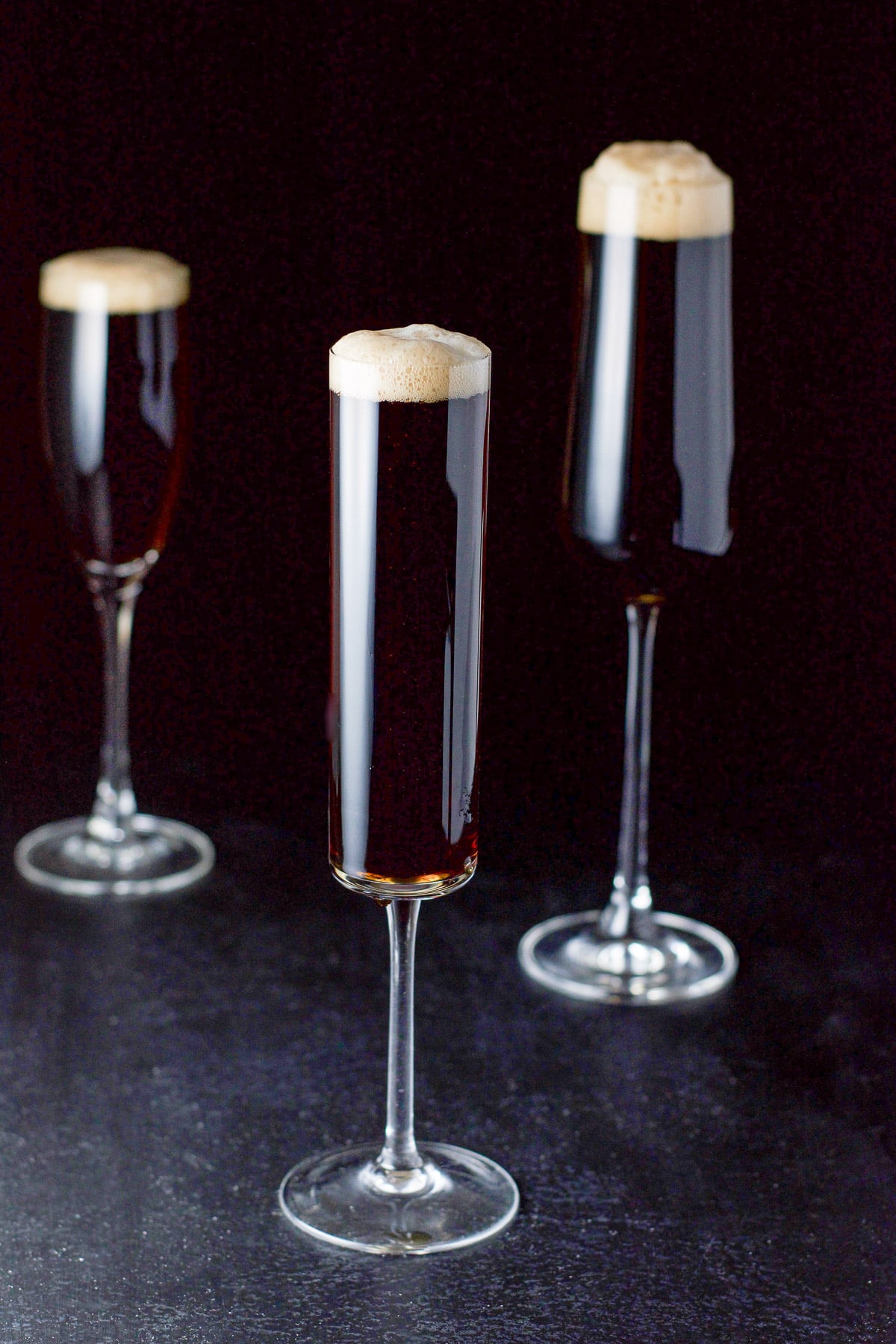 Three champagne glasses of the guinness cocktail