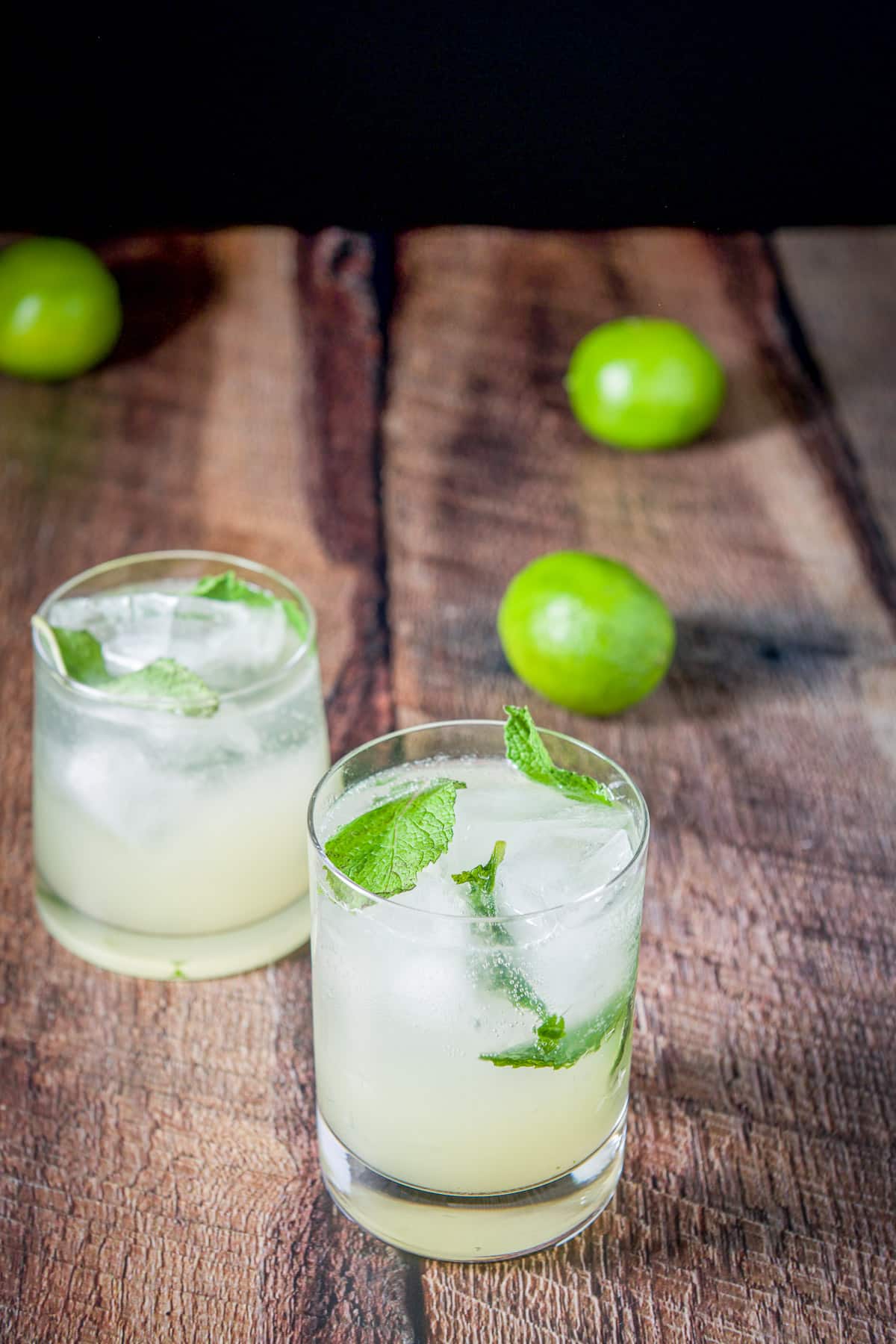 Club soda poured into the mojito with extra mint in the glass