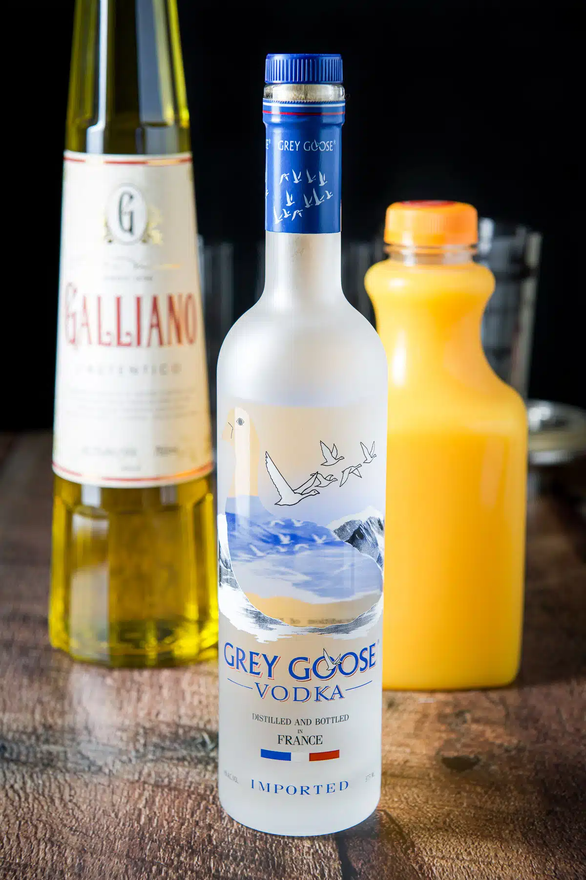 Vodka, orange juice and galliano on a table