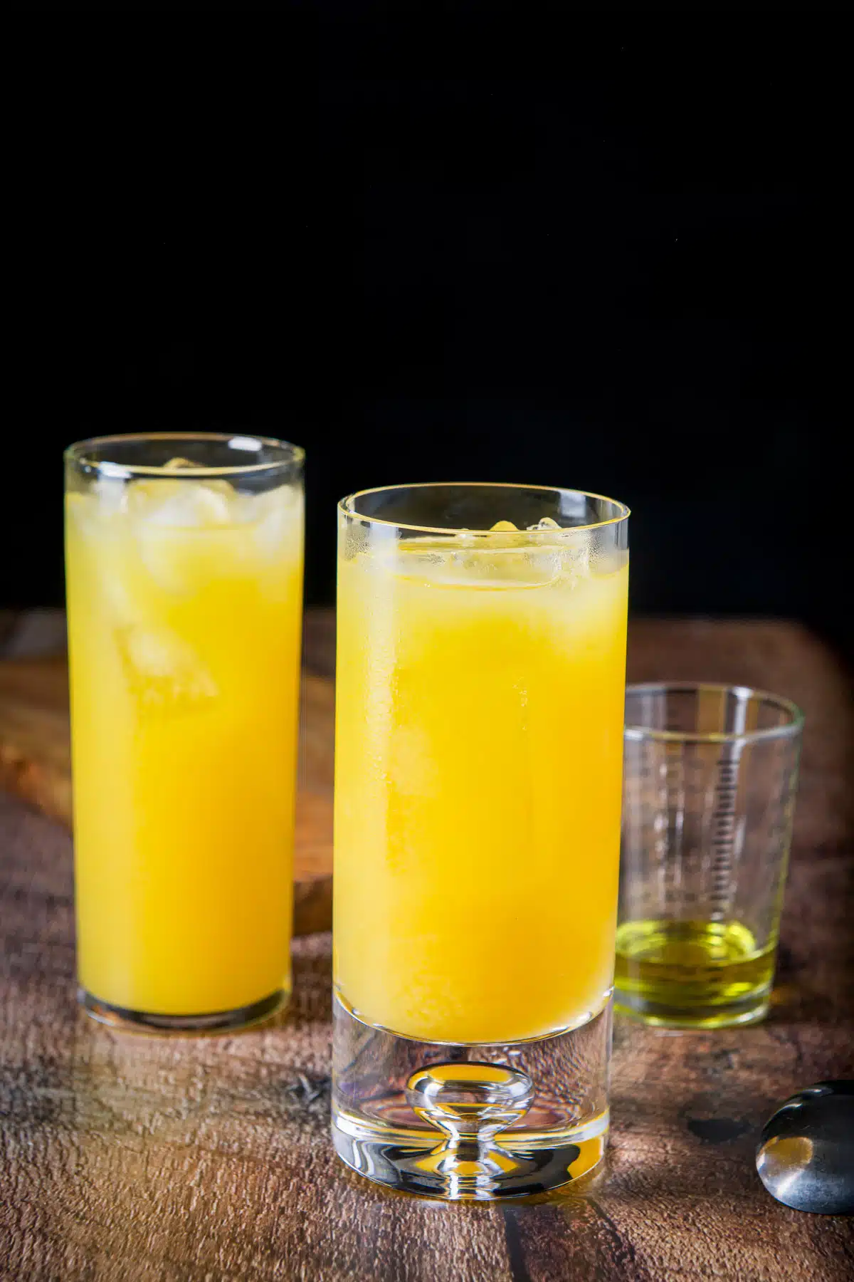 The orange juice poured into the glasses with galliano in the back