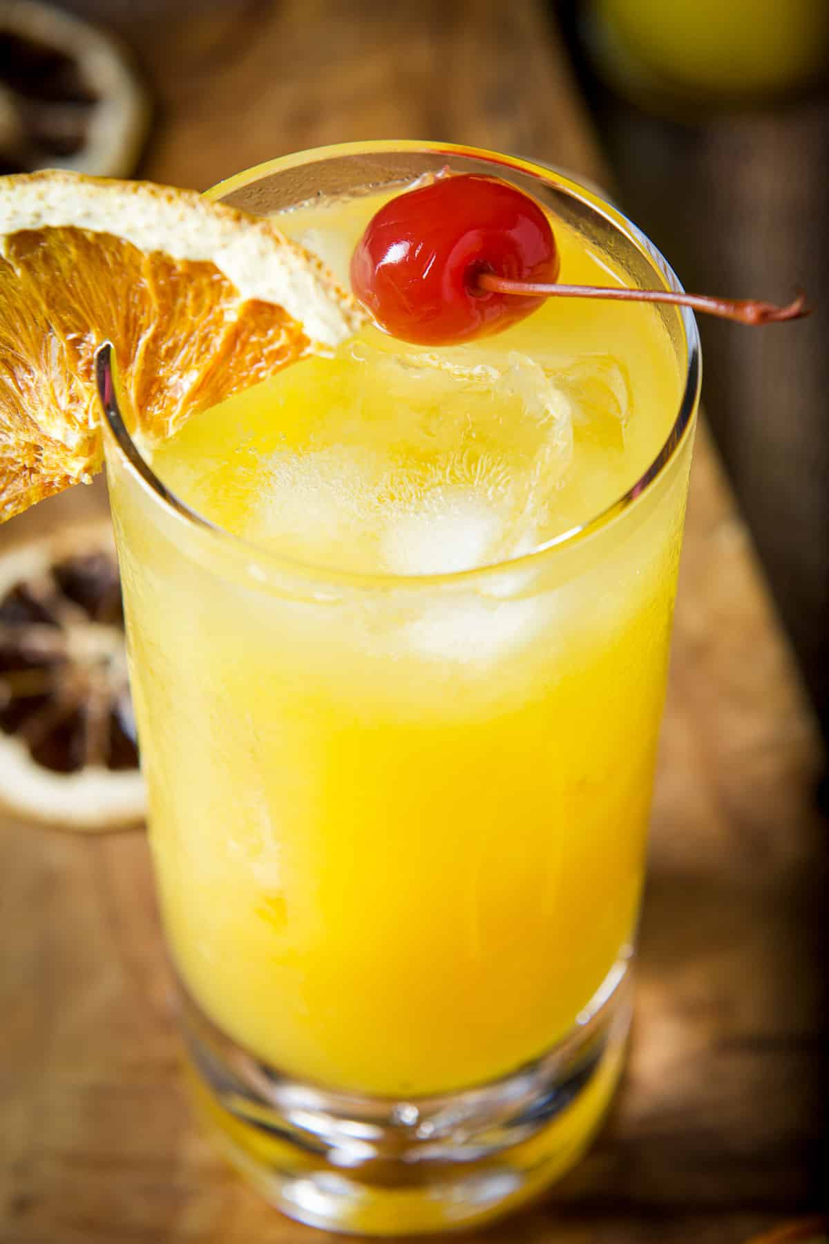 Close up of the wallbanger with a cherry in it and an orange slice on the rim