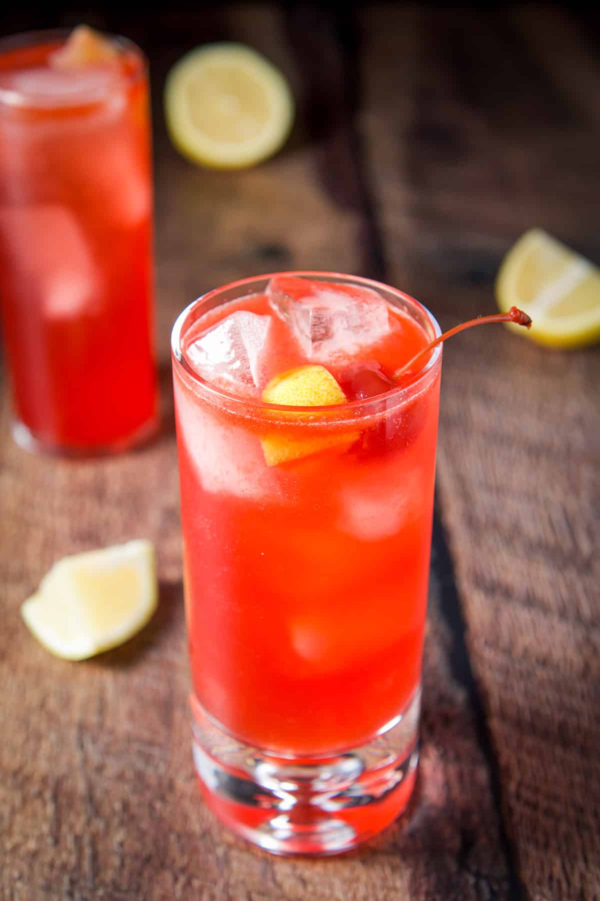 Close view of the sloe gin fizz with cherries and lemon as garnish