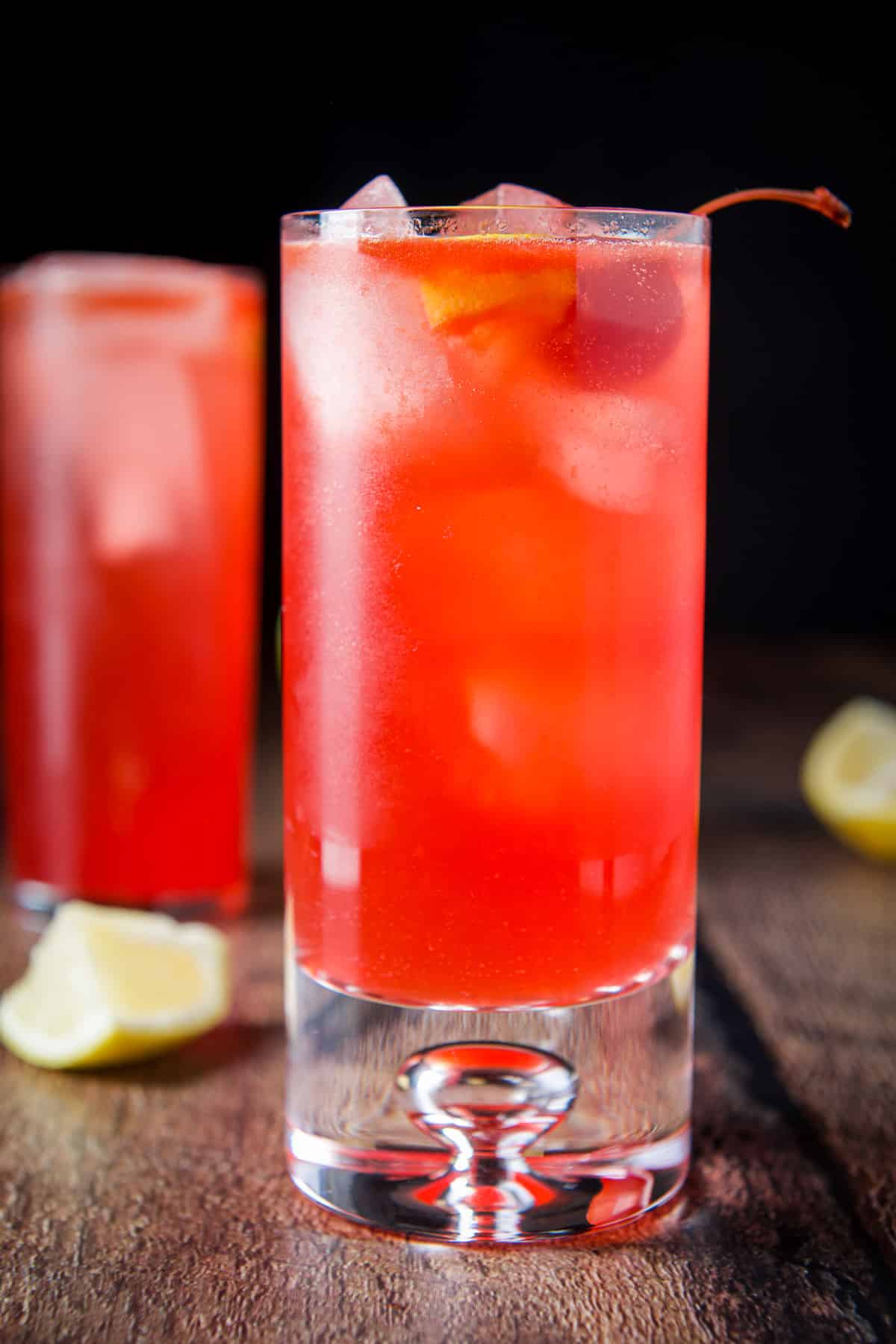 Vertical view of the bubble glass with the red fizzy cocktail in it