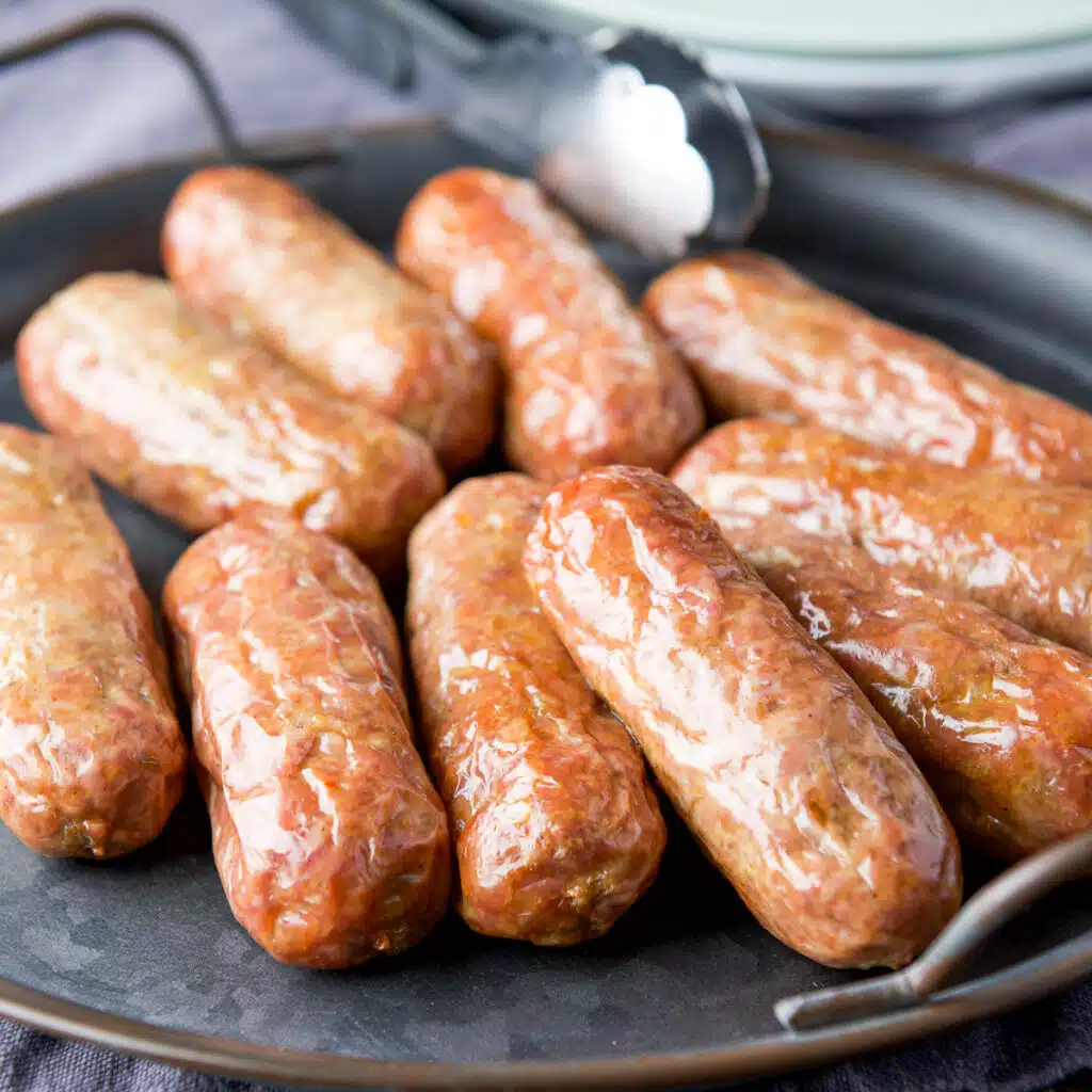 square photo of sausages on a plate