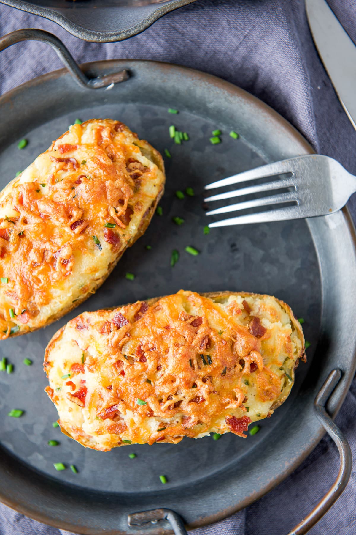 Overhead view of the potato on a metal plate with a fork on it