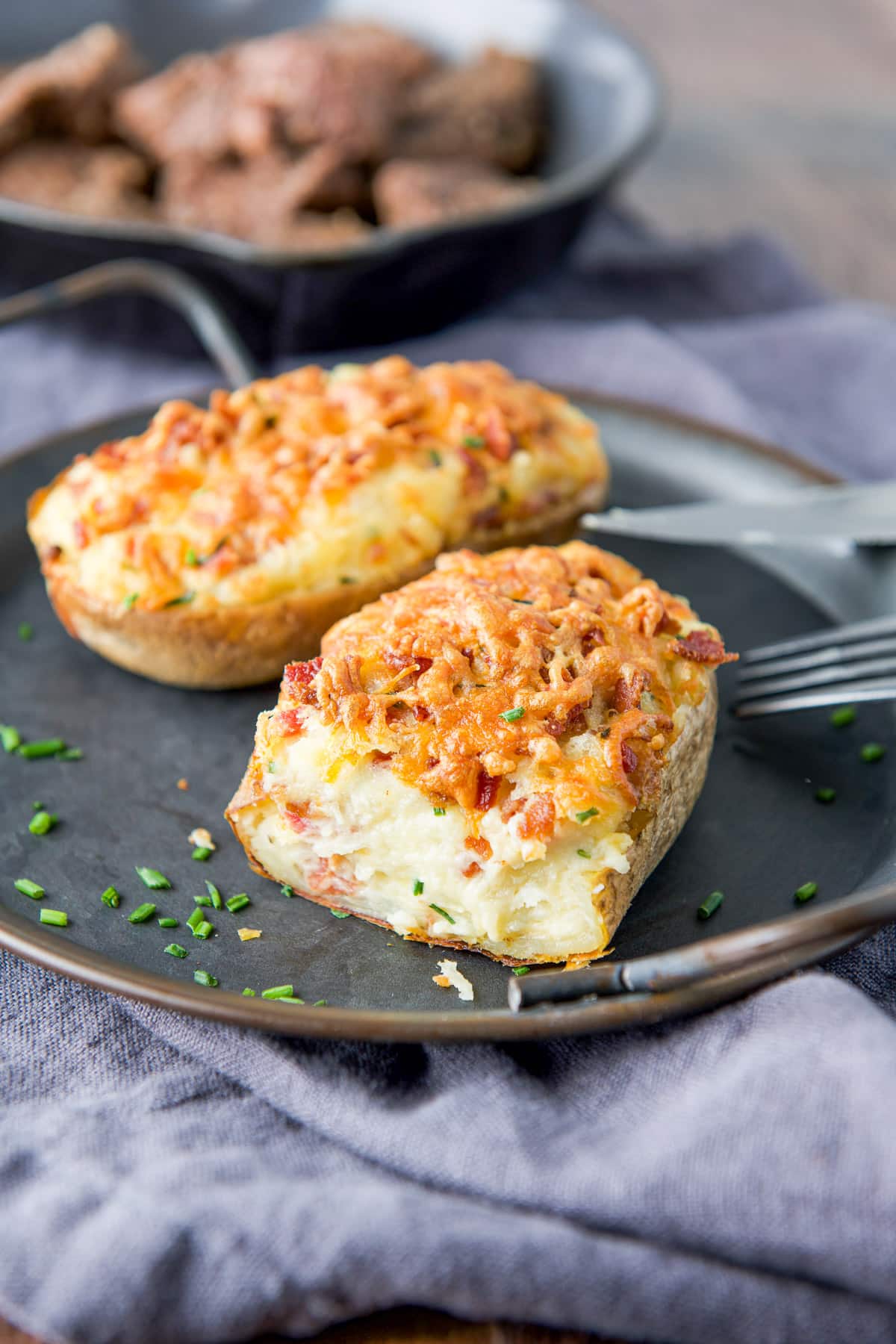 Close photo of a creamy potato with bacon and cheese