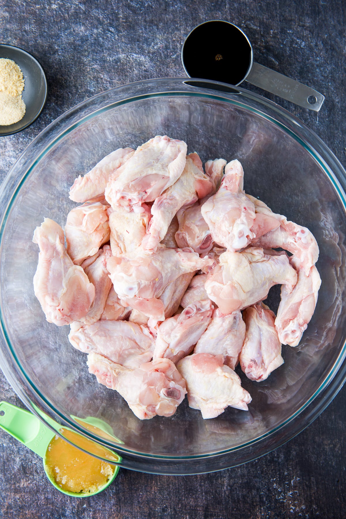 Overhead view of wings in a bowl with honey, soy, and garlic powder