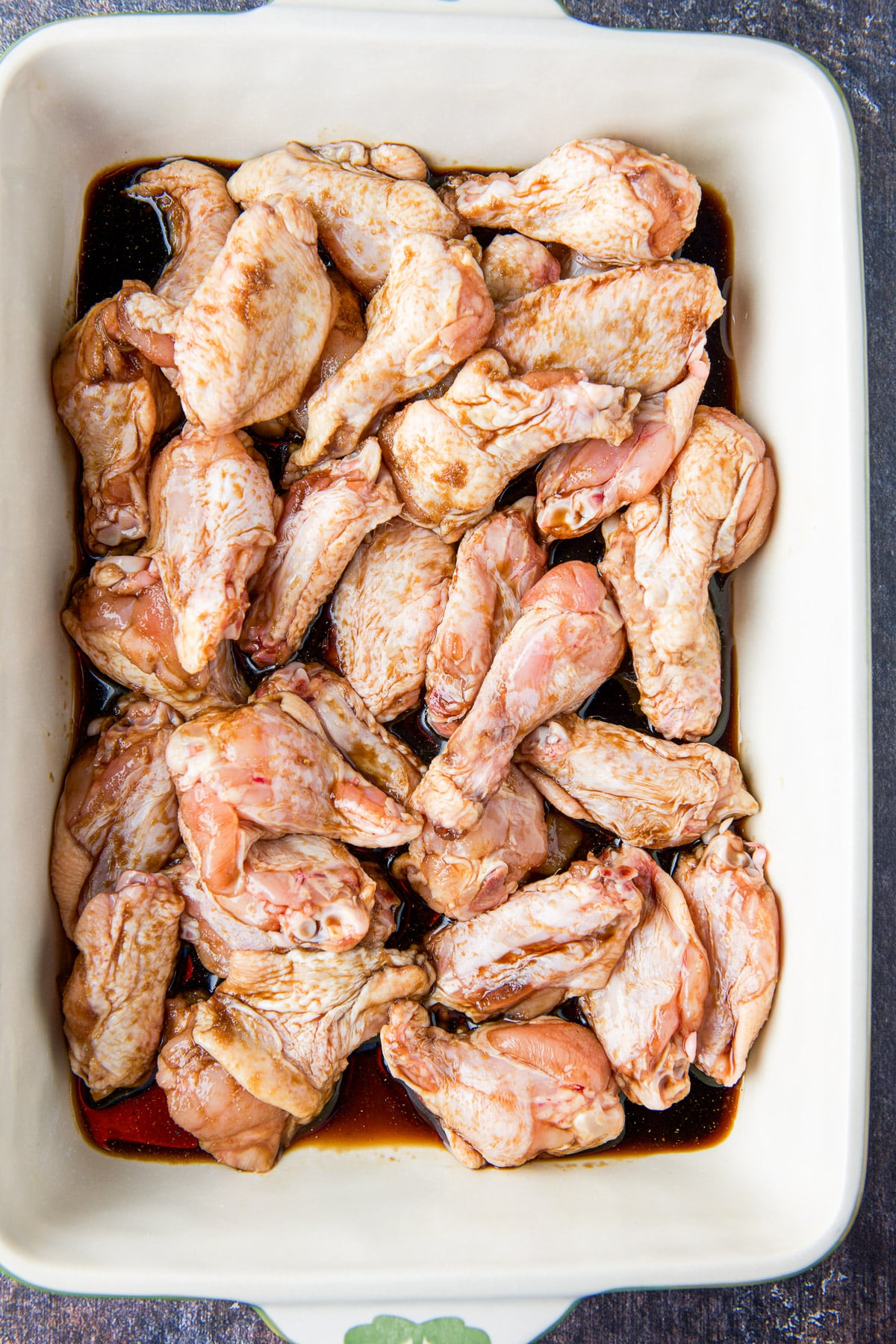 the chicken wings with sauce in a baking dish
