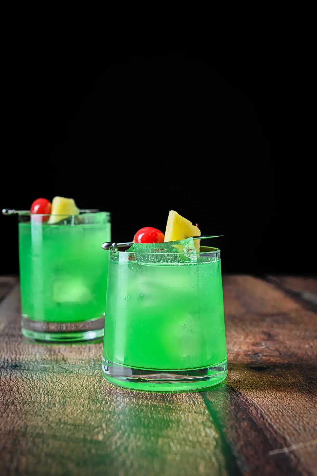 Two glasses with the green Irish cocktail on a board