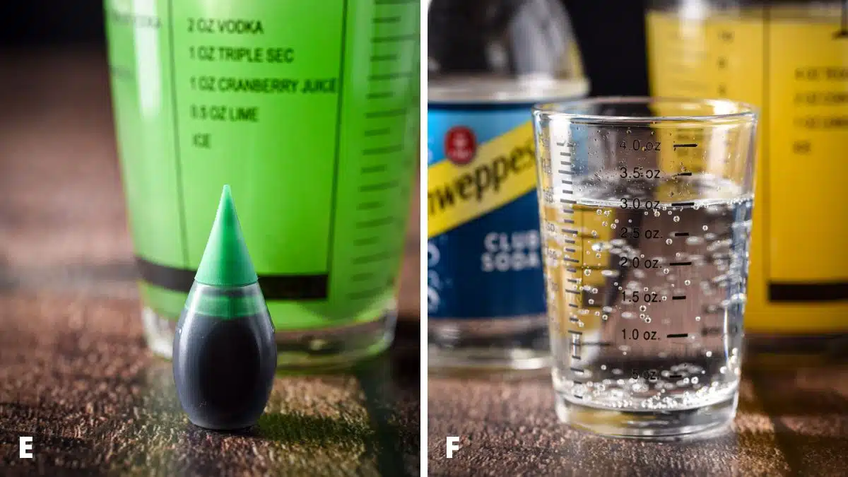 A bottle of green food coloring in front of a shaker and club soda in front of the bottle
