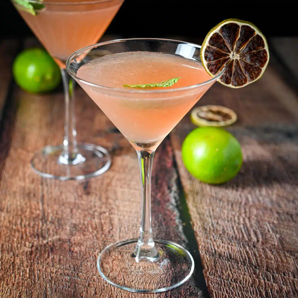 square photo of the berry martini in the glasses with lime as garnish