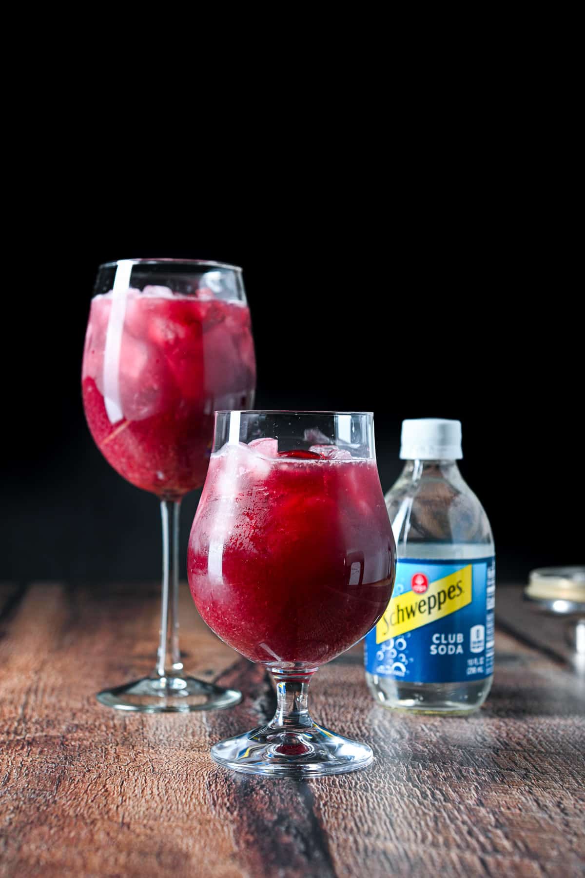 The sangria ingredients poured into the glassware and club soda off to the side