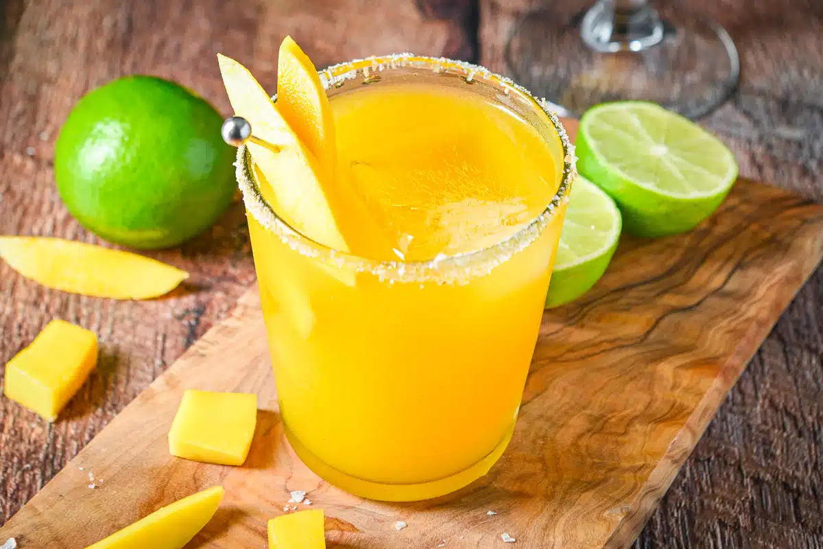 horizontal photo of the yellow margarita with limes and mangos
