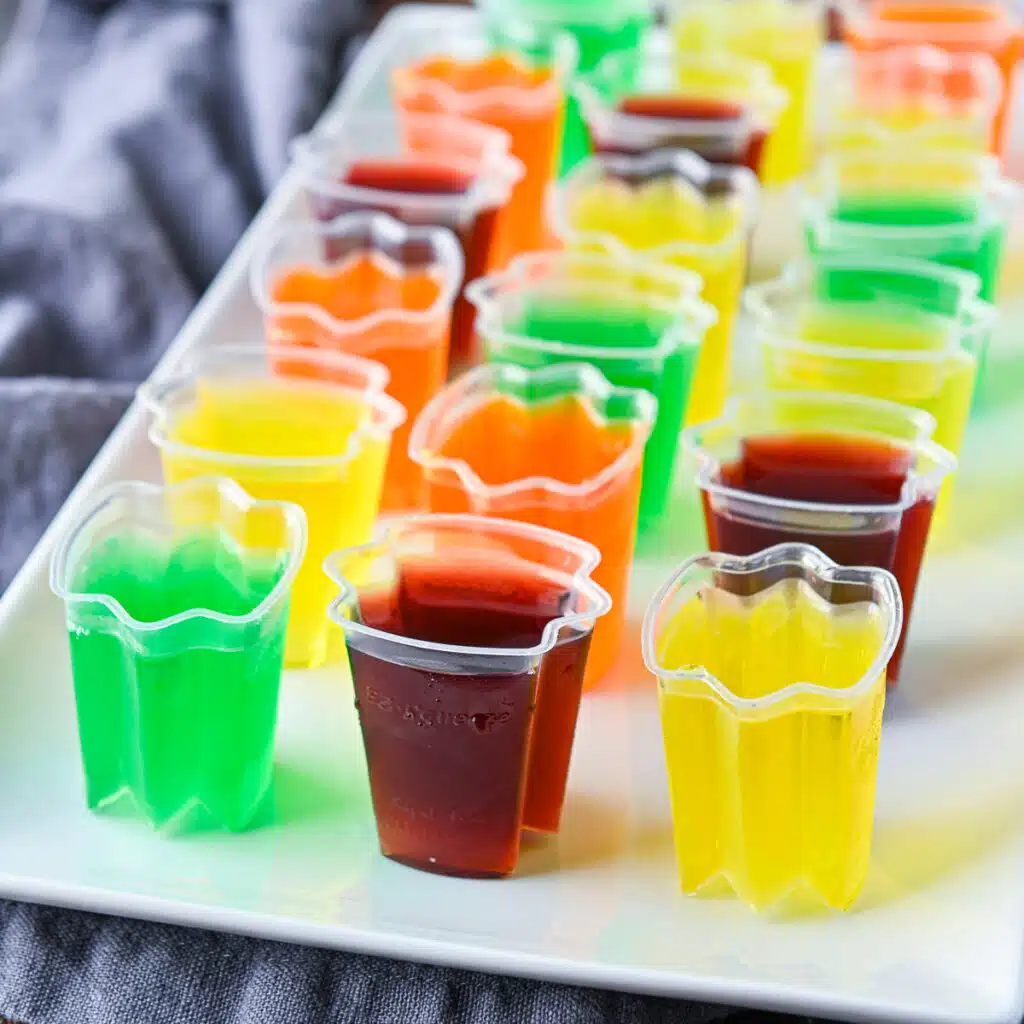 square photo of jello shots on a white platter