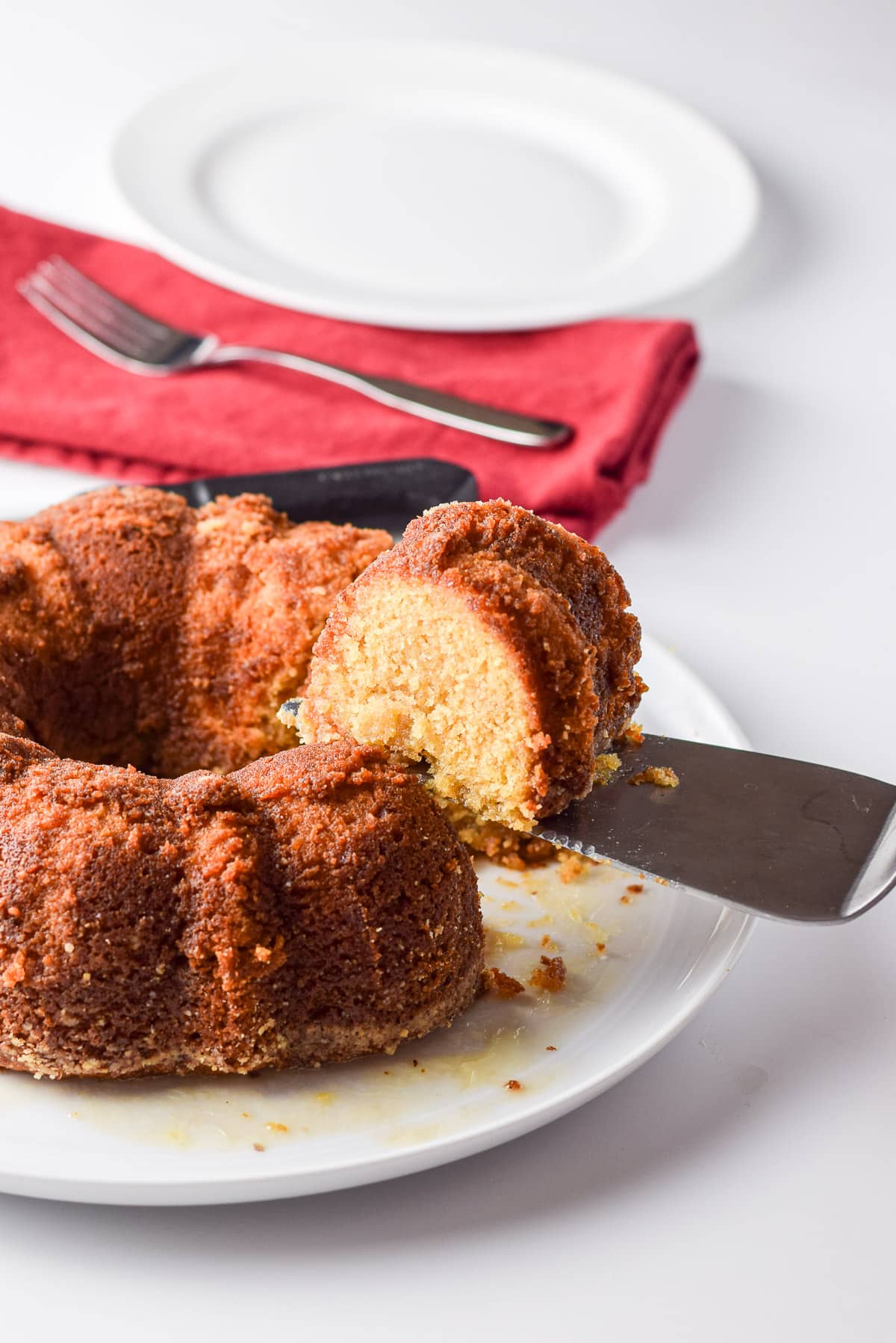 A cake server holding a slice of cake on it