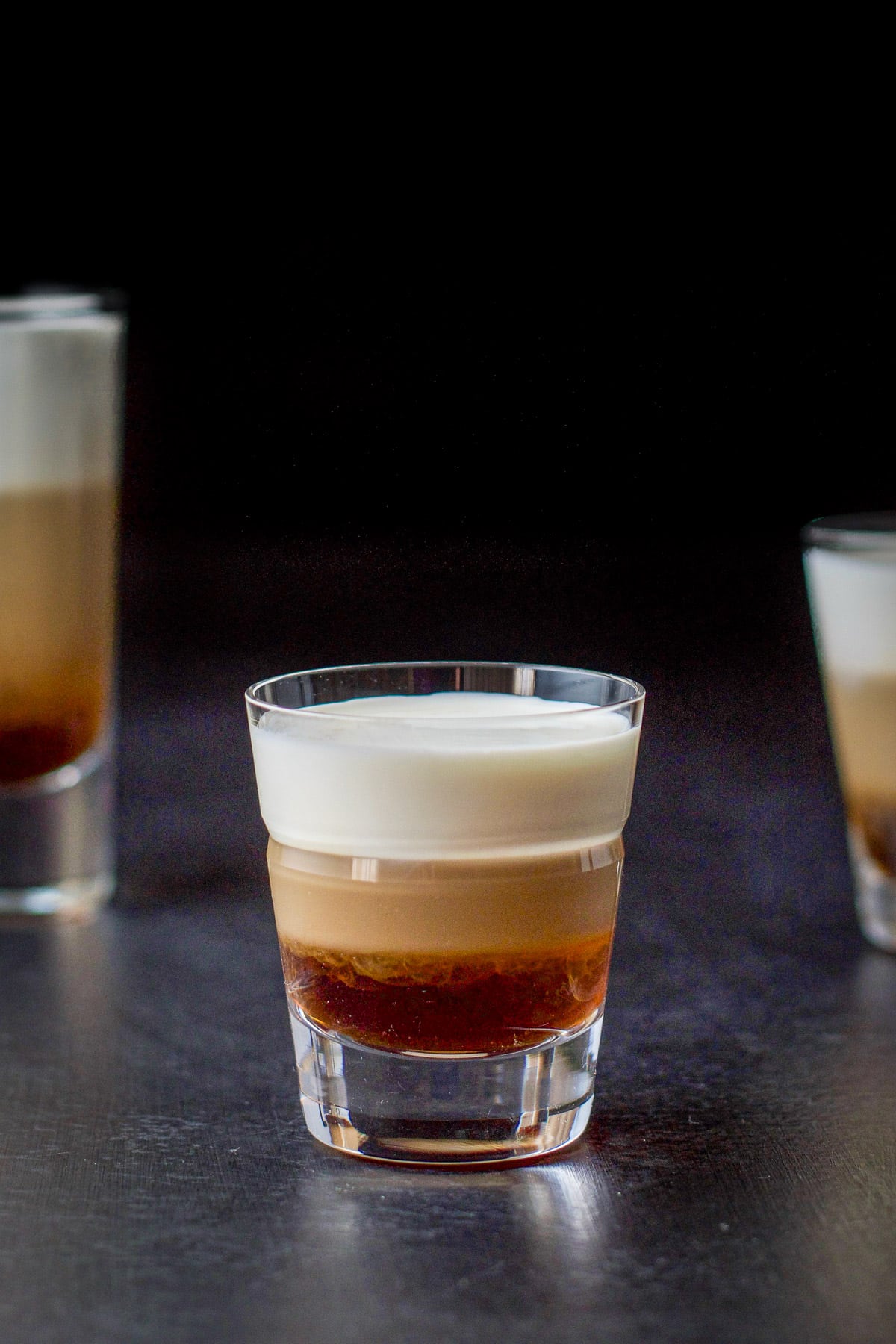 Close view of the middle shot glass with the tootsie roll shot in it