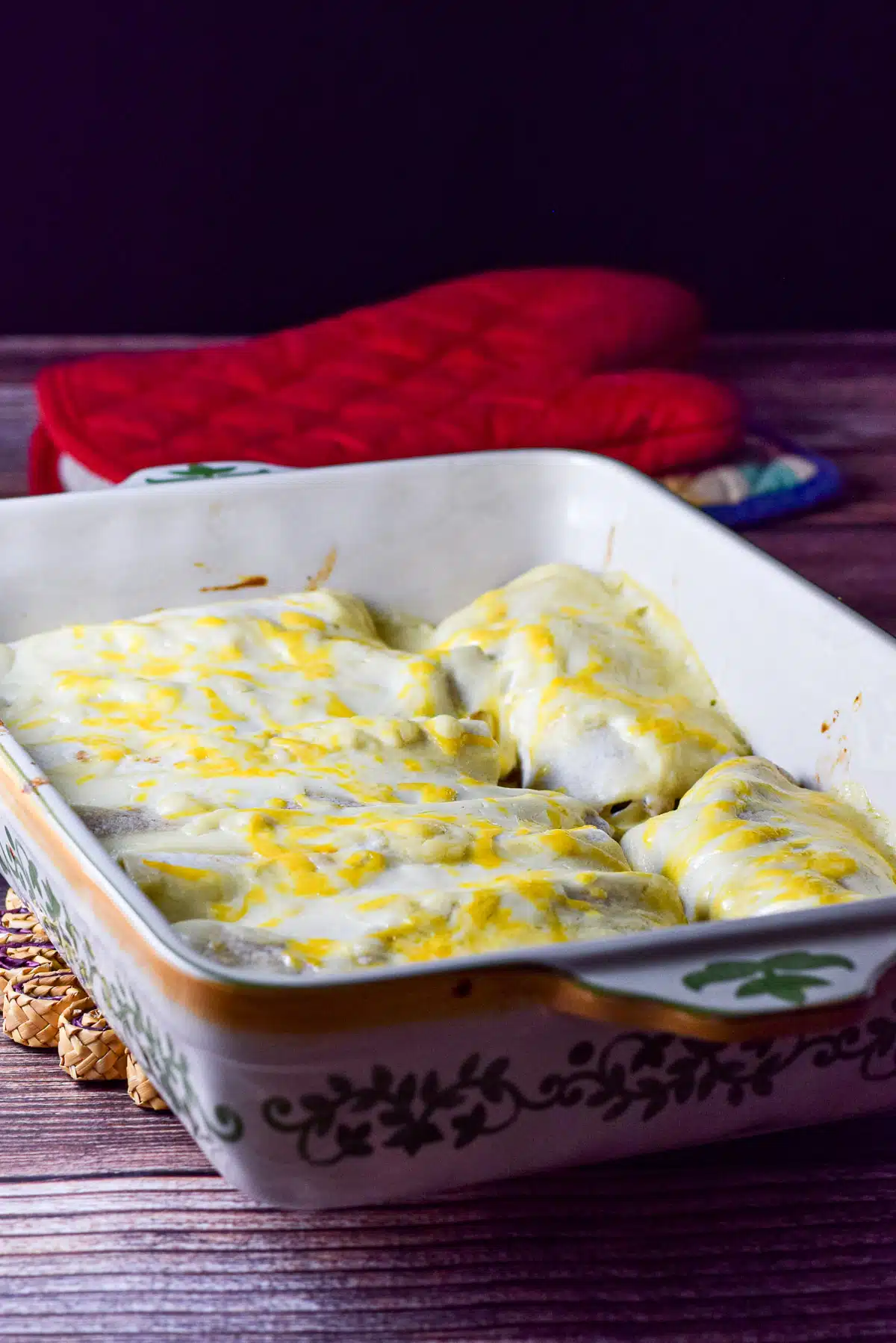 a baking dish filled with enchiladas with white sauce