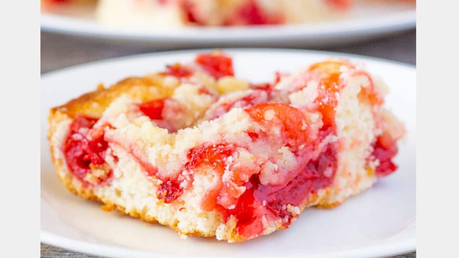 a white plate with a cherry coffee cake on it
