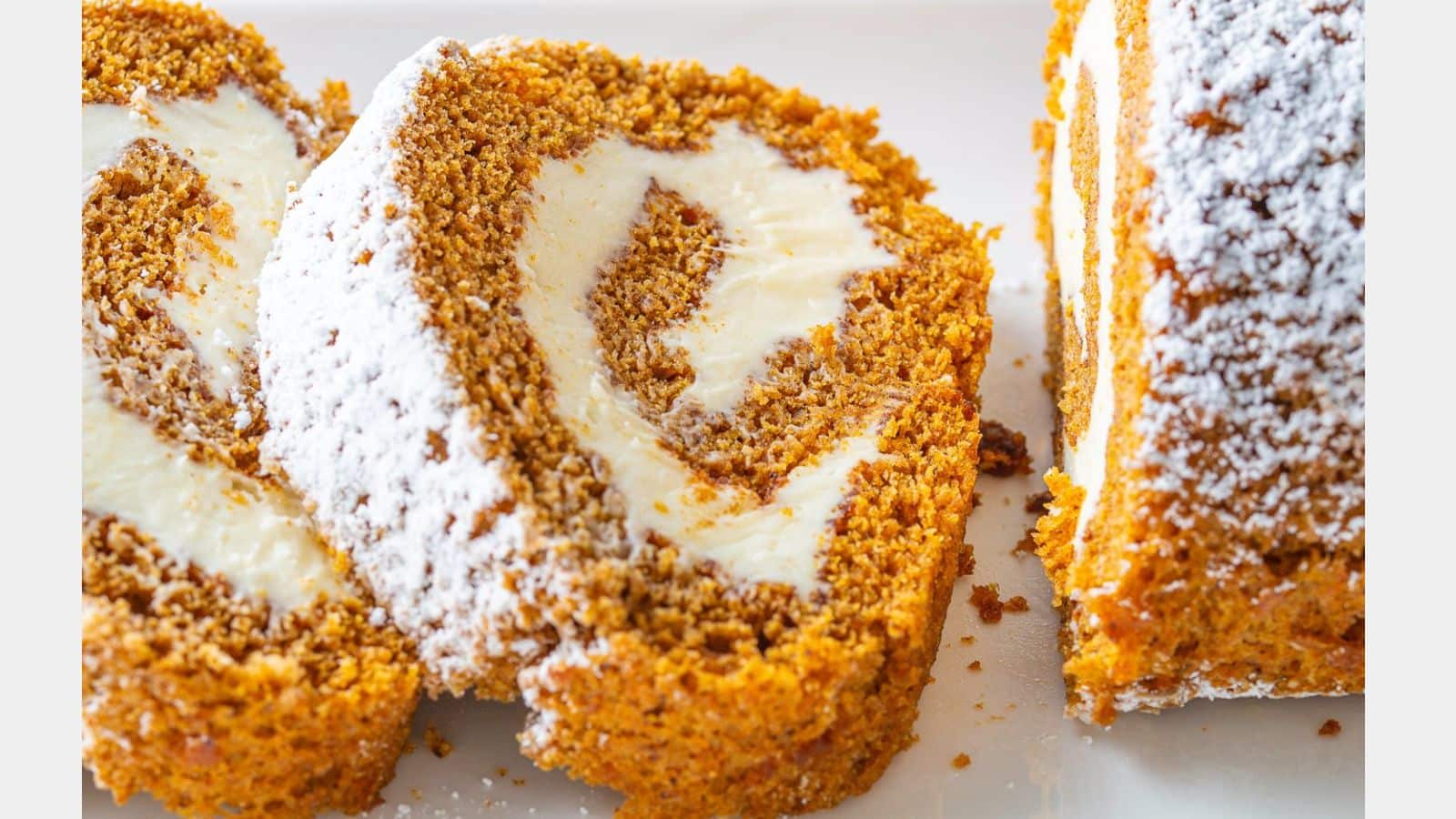 A pumpkin roll slices with delicious frosting in the roll