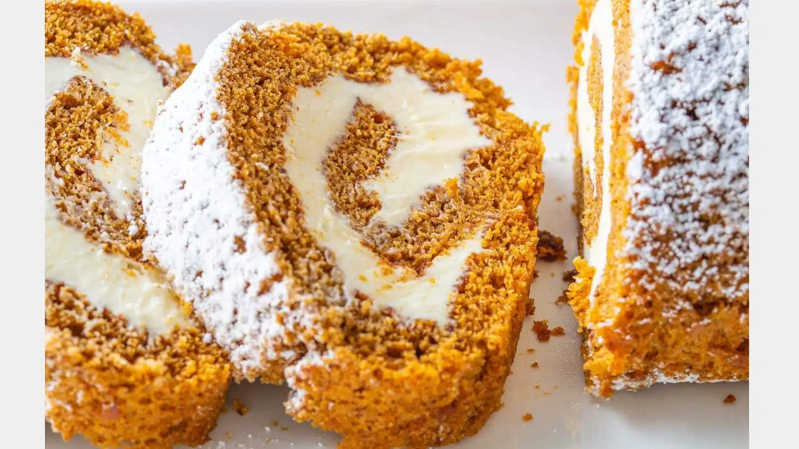 A pumpkin roll slices with delicious frosting in the roll