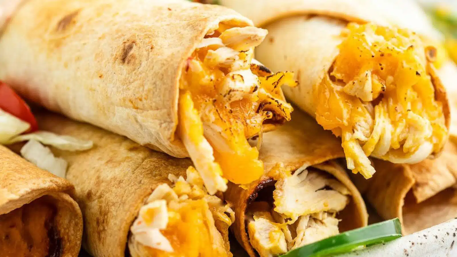 close up of flautas filled with chicken and cheese stacked on each other